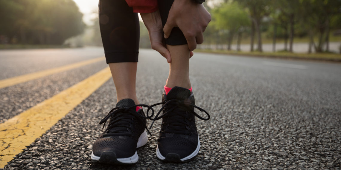 Femme coureur touchant le sport mollet blessé